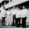 Bob Hino (second from left) general manager, MASDELCO, and Donald Marshall, (third from left) at LUSTEVECO headquarters in Manila, Philippines, late 1950s - From the private collection of Itsue Hino (used with permission)